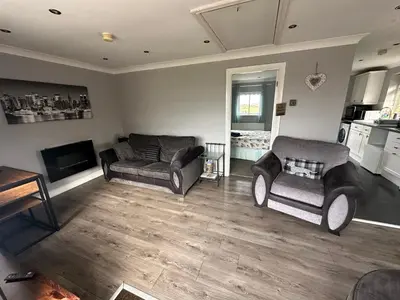 a living room with two couches and a tv at The Bungalow in Preston