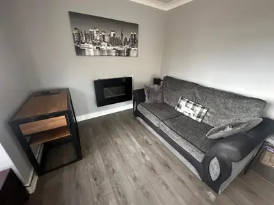 a living room with a couch and a table at The Bungalow in Preston