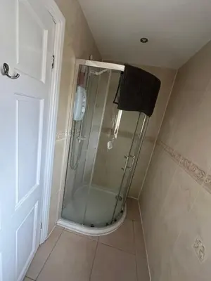a shower with a glass door in a bathroom at The Bungalow in Preston