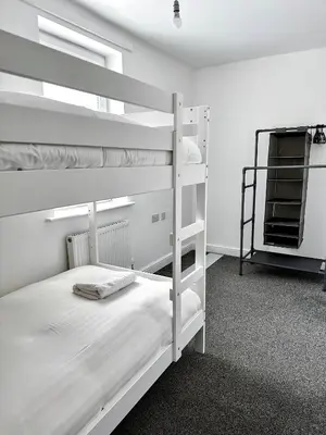 a bedroom with two bunk beds in a room at Relax Inn in Liverpool