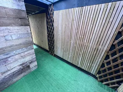 a room with wooden walls and green flooring at The White House New York Suites in Blackpool