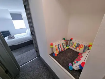 a small room with a toddler bed and a mirror at The White House Vegas Suites in Blackpool