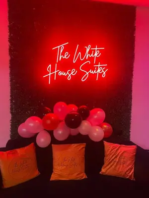 a neon sign that says the little house parties with balloons at The White House Vegas Suites in Blackpool