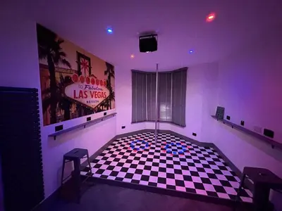 a room with a checkered floor and a sign at The White House Vegas Suites in Blackpool