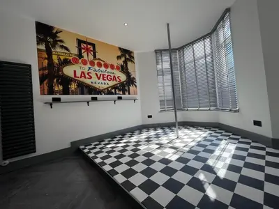 a room with a checkered floor and a las vegas sign at The White House Vegas Suites in Blackpool