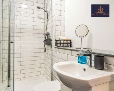 a white bathroom with a sink and a shower at Swan House Apartment 4 - 1 Bed Apartment - Sleeps up to 4 - Free Parking - Liverpool - close to city centre - By ALL ELITE STAYS in Liverpool