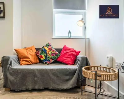a couch with colorful pillows on it in a room at Swan House Apartment 4 - 1 Bed Apartment - Sleeps up to 4 - Free Parking - Liverpool - close to city centre - By ALL ELITE STAYS in Liverpool