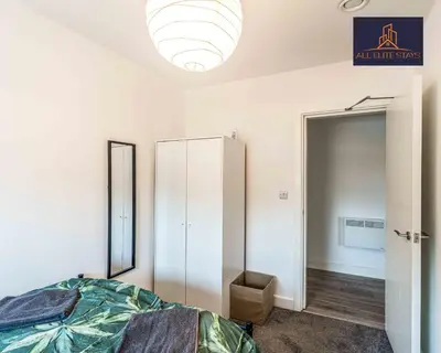 a bedroom with a bed and a closet and a mirror at Swan House Apartment 4 - 1 Bed Apartment - Sleeps up to 4 - Free Parking - Liverpool - close to city centre - By ALL ELITE STAYS in Liverpool