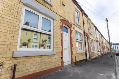 a brick building with a white door and windows at Teck House - Air Host & Stay - 5 mins to Hospital in Liverpool