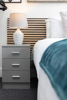 a bedroom with a bed and a nightstand with a lamp at Teck House - Air Host & Stay - 5 mins to Hospital in Liverpool