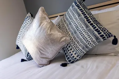 a bed with three pillows on top of it at Teck House - Air Host & Stay - 5 mins to Hospital in Liverpool
