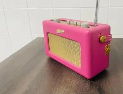 a pink suitcase sitting on top of a table at Magenta Melodies, 5 Bedroom House in Blackpool