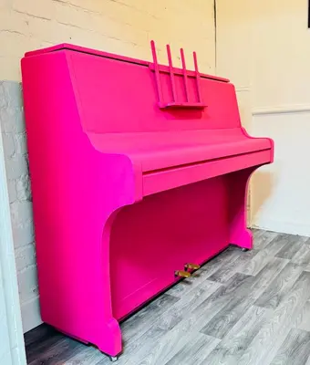 a bright pink piano sitting in a room at Magenta Melodies, 5 Bedroom House in Blackpool