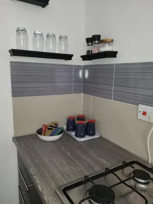 a kitchen with a stove and a counter with cups at House 36 in Liverpool