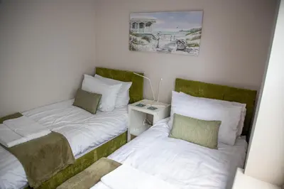 two twin beds in a room with at Wave Stays - Ground Floor Apartment - Outside Seating Area in Cleveleys