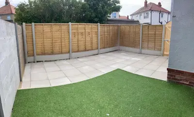 a patio with a fence and green grass at Wave Stays - Ground Floor Apartment - Outside Seating Area in Cleveleys