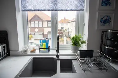 a kitchen with a sink and a window at Wave Stays - First Floor Apartment - Heart of Cleveleys in Cleveleys