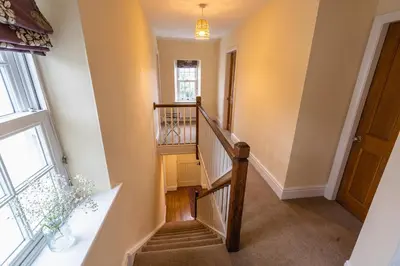 a winding staircase in a house with a window at Entire cottage & private garden in Scorton in Scorton