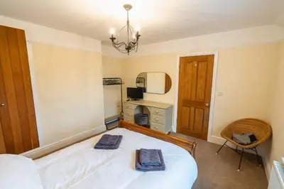 a bedroom with a bed with two towels on it at Entire cottage & private garden in Scorton in Scorton