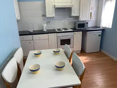 a kitchen with a table and chairs with bowls on it at Abbey Road in Liverpool