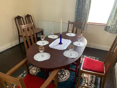 a dining room table with wine glasses on it at Abbey Road in Liverpool