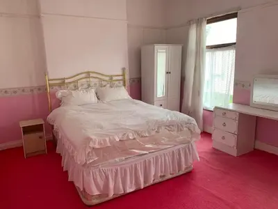 a bedroom with a large bed and a window at Abbey Road in Liverpool