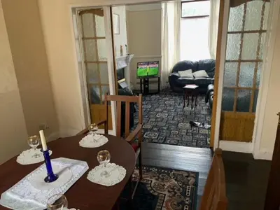 a living room with a dining table and a living room with a living room at Abbey Road in Liverpool