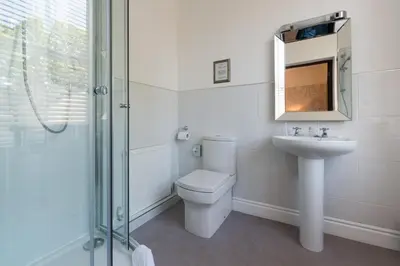a bathroom with a toilet and a sink and a shower at The Swan Hotel in Clitheroe