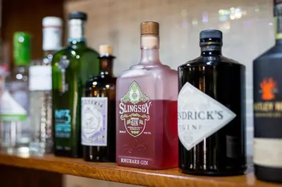 a group of bottles of wine sitting on a shelf at The Swan Hotel in Clitheroe