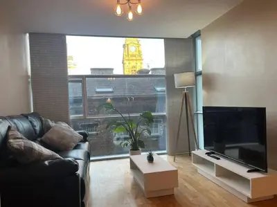 a living room with a large television and a large window at MC Apartment - Central 