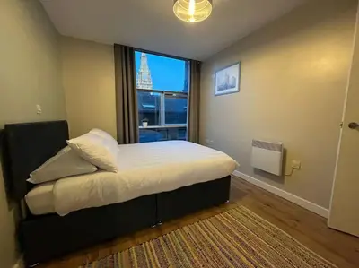 a bedroom with a bed with a large window at MC Apartment - Central 