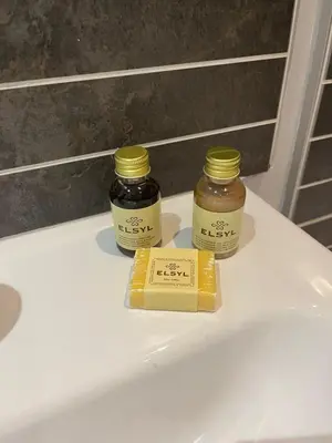 two jars of honey and a box of butter on a sink at MC Apartment - Central 