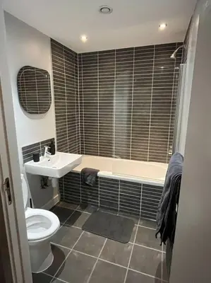 a bathroom with a toilet and a tub and a sink at MC Apartment - Central 