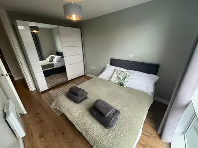 a bedroom with a bed with two pillows and a mirror at MC Apartment - Central 