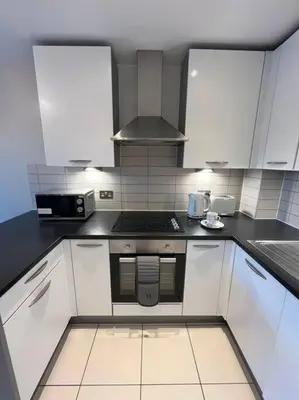 a kitchen with white cabinets and a stove at MC Apartment - Central 
