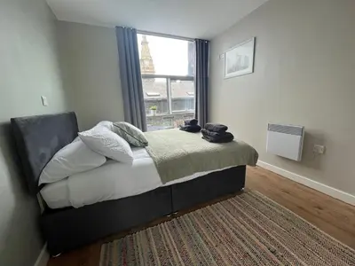a bedroom with a bed with a window and a rug at MC Apartment - Central 