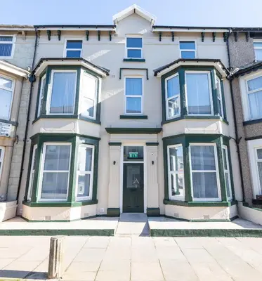 a large white house with a green door at Charles Alexander Short Stay - TheWestern Blackpool in Blackpool