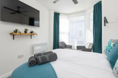 a bedroom with a bed with a towel on it at Charles Alexander Short Stay - TheWestern Blackpool in Blackpool