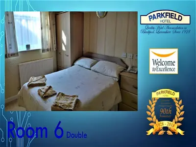 a bedroom with a bed with a welcome marriott sign at Parkfield Hotel in Blackpool