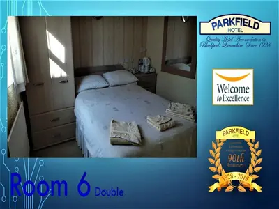 a bedroom with a bed with a welcome marriott sign at Parkfield Hotel in Blackpool