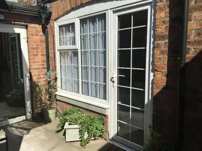 a large window on the side of a brick building at The Bungalow and Studio Apartments in Lytham St Annes