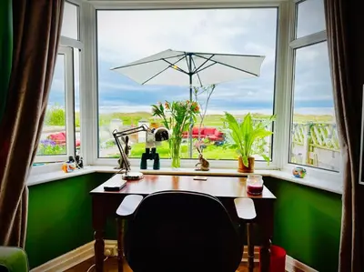 a desk in front of a window with a view at Liverpool - Cosy Jazzy Beach Home! in Waterloo
