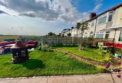 a yard with a house and a garden with a fire hydrant at Liverpool - Cosy Jazzy Beach Home! in Waterloo
