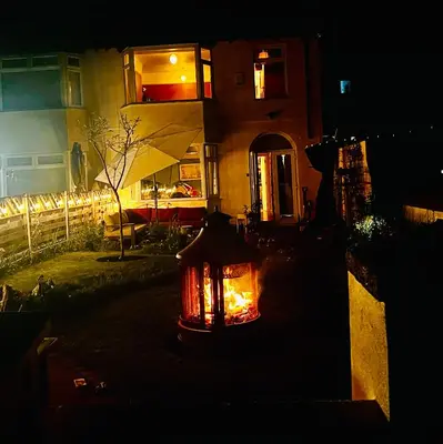 a lantern in the yard of a house at night at Liverpool - Cosy Jazzy Beach Home! in Waterloo