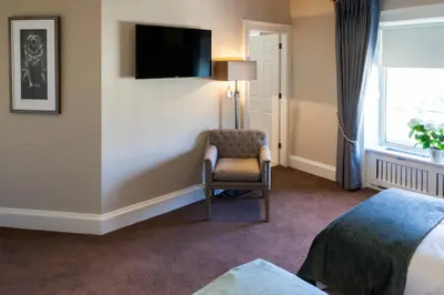 a hotel room with a chair and a television at The Borough Lancaster in Lancaster