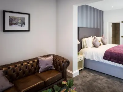 a bedroom with a bed and a leather couch at The Borough Lancaster in Lancaster