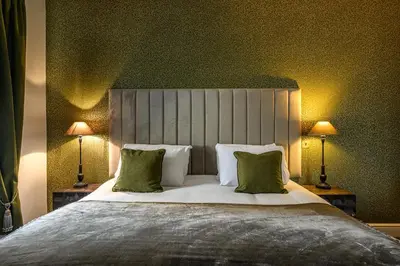 a bedroom with a large bed with two lamps at The Borough Lancaster in Lancaster
