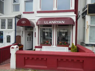 a red building with a sign for a law firm at Llanryan Guest House in Blackpool