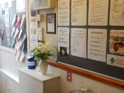 a wall with a bunch of menus on the wall at Llanryan Guest House in Blackpool