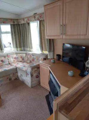 a living room with a couch and a flat screen tv at Marina Retreat in Haverigg
